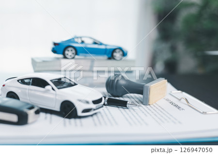 Approved car loan application with car key, rubber stamp and calculator concept. financial document on wooden table. Asset approval purchases to buy car. Ideas for car buying checklist loan tax Approved car loan application with car key, rubber stamp and calculator concept. financial document on wooden table. Asset approval purchases to buy car. Ideas for car buying checklist loan tax 126947050