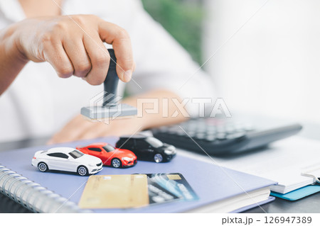 Businesswoman hand stamp approve on financial business approval document paper. Man hand accept permit contract agreement. Broker manager sign contract bank guarantee approved stamp application form Businesswoman hand stamp approve on financial business approval document paper. Man hand accept permit contract agreement. Broker manager sign contract bank guarantee approved stamp application form 126947389