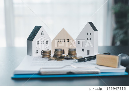 Rubber stamp calculator and loan house model on table with home loan approved on loan application form document paper, approval business finance economy commercial real estate investments concept. Rubber stamp calculator and loan house model on table with home loan approved on loan application form document paper, approval business finance economy commercial real estate investments concept. 126947516