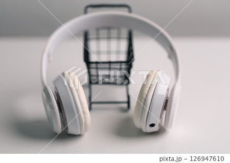 New technology modern Close up high resolution Wireless Earphones white Earbuds headphones black blur background Trendy minimal music device laptop concept phone accessories Comfortable Wooden table 126947610