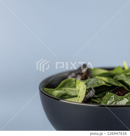 Fresh Green Salad with Spinach, Leafy Greens, and Cherry Tomatoes in Bowl 126947816
