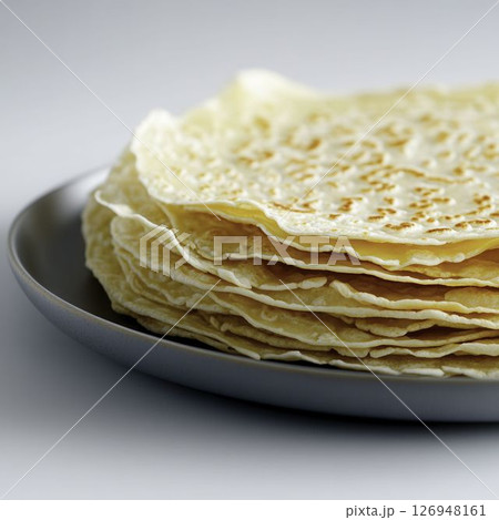 Freshly Made Thin Flatbreads Stacked on a Gray Plate with a Soft Background 126948161