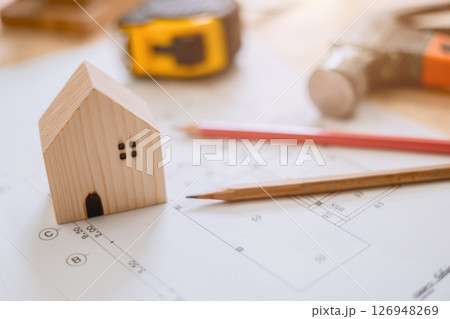 small wooden home on architect floor plan, House designer architecture background concept 126948269