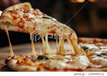 Delicious cheese pizza being served with melting mozzarella Delicious cheese pizza being served with melting mozzarella 126948312