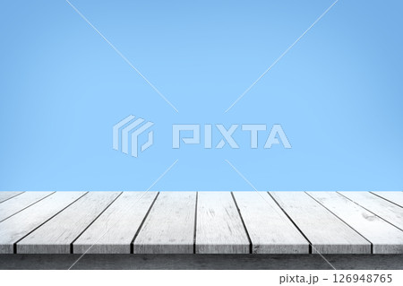 Empty white wooden table top on blue background, used for display or montage your products. Empty white wooden table top on blue background, used for display or montage your products. 126948765