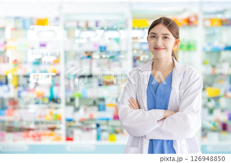 Portrait Pharmacist in drug store, Doctor with pharmacy shelf storage background confident happy 126948850