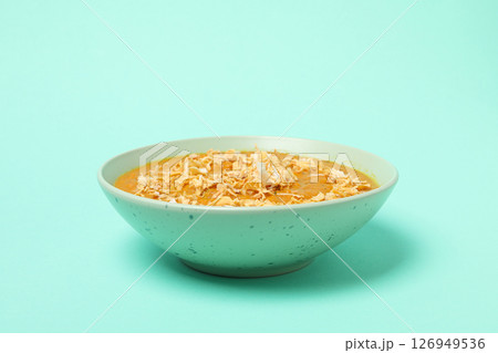 Sweet potato puree in bowl on green background 126949536
