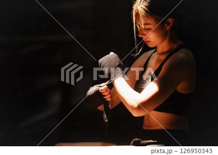Muay thai, strong women fighter wrapped fist to Bare Knuckle fighting Asian kick boxing style people 126950343