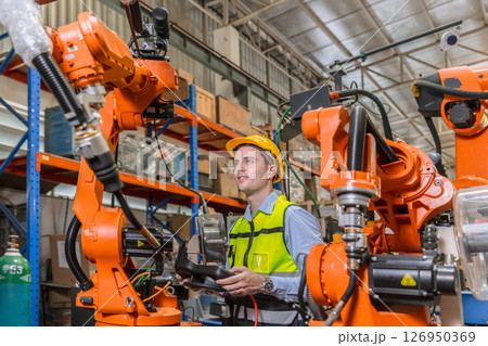 professional engineer, robotic technician work in modern factory industrial robot welding arm machine control operator 126950369