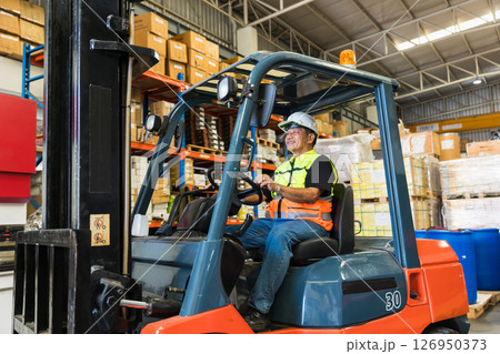 warehouse worker man forklift driver happy smiling enjoy staff working. asian male factory cargo shipping worker warehouse worker man forklift driver happy smiling enjoy staff working. asian male factory cargo shipping worker 126950373