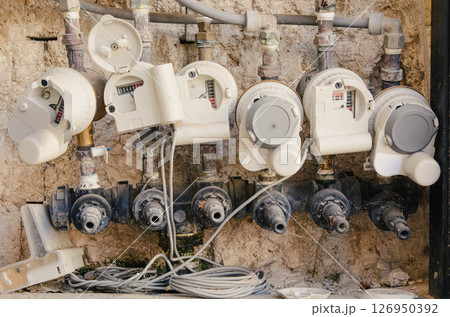 Multiple Water Meters on Building Wall Multiple Water Meters on Building Wall 126950392
