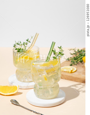 Two glasses of mocktail mojito with lemon, lime, thyme and ice. Citrus lemonade 126951080