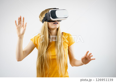 Girl wearing virtual reality goggles. Girl wearing virtual reality goggles. 126951139