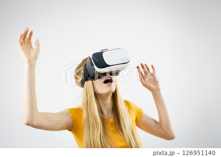 Girl wearing virtual reality goggles. 126951140
