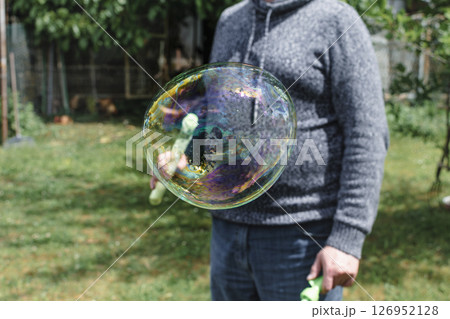 Soap bubble, outdoors activity and leisure for happy kid, real life photo 126952128