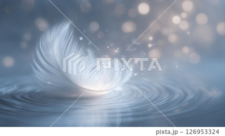 single dove feather resting on a quiet water surface with faint ripples 126953324
