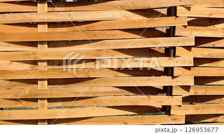 wooden fence in rural setting on sunny day, highlighting craftsmanship and natural beauty. closeup. 126953677