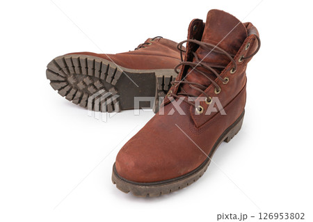 Pair of brown suede boots on white background. Pair of brown suede boots on white background. 126953802