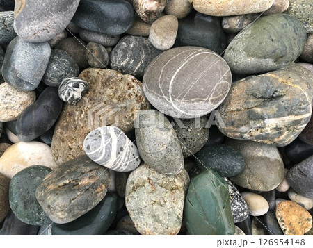 Natural pebble texture background with multicolored river or sea stones. Natural pebble texture background with multicolored river or sea stones. 126954148