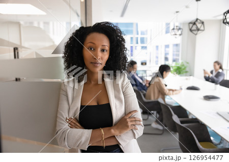 Portrait of African businesswoman standing at entrance of meeting room 126954477