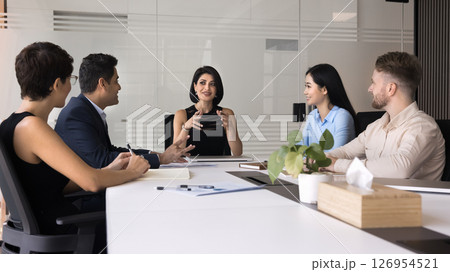 Attractive businesswoman and teammates collaborating on presentation Attractive businesswoman and teammates collaborating on presentation 126954521