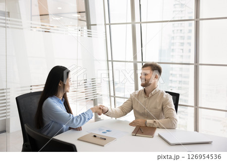 Multiethnic businesspeople giving handshake finalize formal meeting in office 126954536