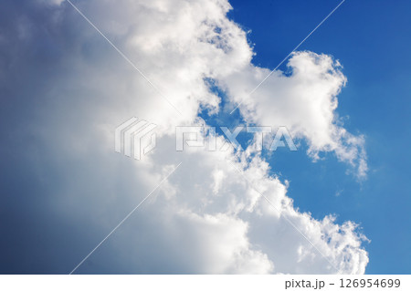 A beautiful blue sky filled with soft white clouds drifting by A beautiful blue sky filled with soft white clouds drifting by 126954699