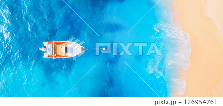 Drone view of the motor boat. Marine transport. Beach and waves. Vacation and holidays. Drone view of the motor boat. Marine transport. Beach and waves. Vacation and holidays. 126954761