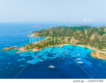 Island in the middle of the sea. Drone view of a yachts, boats and island. Vacationing people. Island in the middle of the sea. Drone view of a yachts, boats and island. Vacationing people. 126954780