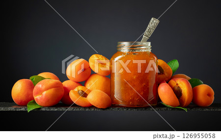 Apricot jam in glass jar and fresh fruits. 126955058