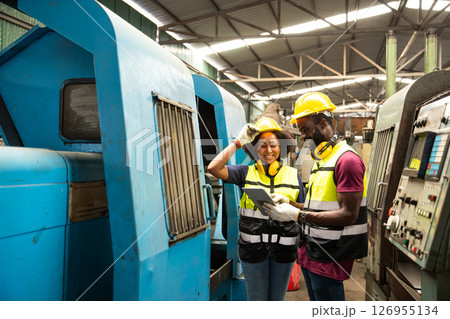 African black man professional technician engineer people workers in heavy industry training control operate CNC machine to young women African black man professional technician engineer people workers in heavy industry training control operate CNC machine to young women 126955134