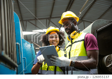 African black man professional technician engineer people workers in heavy industry training control operate CNC machine to young women 126955137