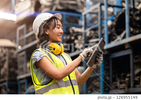Happy Asian women engineer staff worker enjoy working in factory heavy industry. 126955149