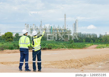 Professional engineer working outdoor, petroleum plant construction team survey site inspection process 126955195