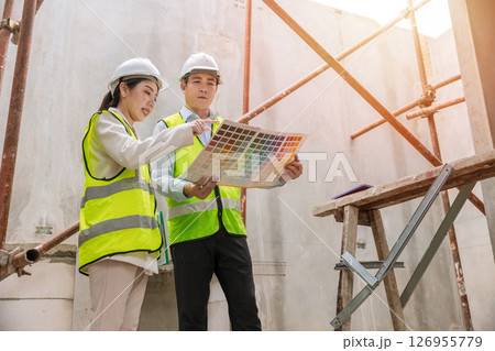 Interior designer team meeting with decorator selection painting, Colors selection process, home project color choice from colors chart 126955779