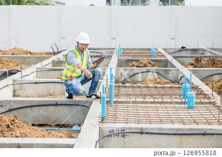 Asian construction engineer, Japanese builder worker male working inspecting footing house building. 126955818