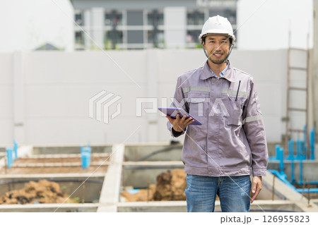 Asian construction engineer, Japanese builder worker male working inspecting footing house building. 126955823