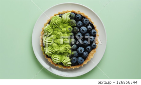 Top of view pie cake topping blueberry and matcha gluten free homemade on solid background 126956544