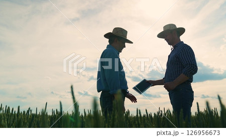 Partnership success in agriculture, Two farmers celebrate partnership, Business handshake in nature, Rural teamwork concept, Deal between agricultural entrepreneurs, Farm contract agreement 126956673