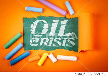 Oil Crisis Concept with Torn Paper and Colorful Chalk on Orange Background Oil Crisis Concept with Torn Paper and Colorful Chalk on Orange Background 126959348