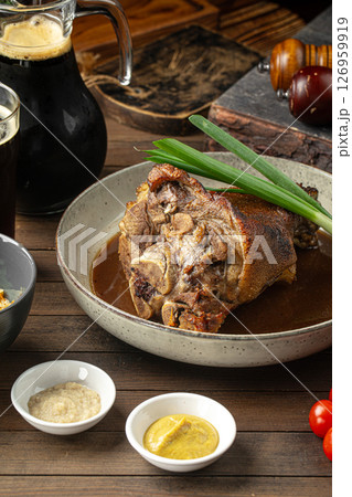 Baked pork knuckle with sauce and spring onion Baked pork knuckle with sauce and spring onion 126959919