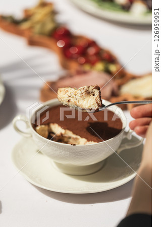 Eating tiramisu dessert in a bowl Eating tiramisu dessert in a bowl 126959951