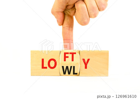Lofty or lowly symbol. Concept words Lofty Lowly on wooden block. Beautiful white table white background. Businessman hand. Business lofty or lowly concept. Copy space. 126961610