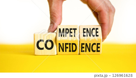 Competence and confidence symbol. Concept word Competence Confidence on wooden cubes. Businessman hand. Beautiful yellow table white background. Business competence confidence concept. Copy space. 126961628