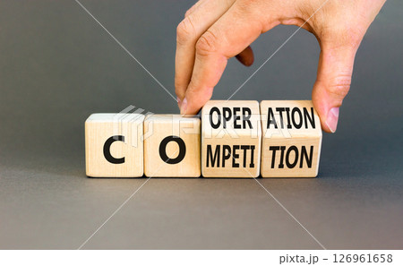 Competition or cooperation symbol. Concept word Competition or Cooperation on wooden cubes. Businessman hand. Beautiful grey background. Business Competition or cooperation concept. Copy space. Competition or cooperation symbol. Concept word Competition or Cooperation on wooden cubes. Businessman hand. Beautiful grey background. Business Competition or cooperation concept. Copy space. 126961658