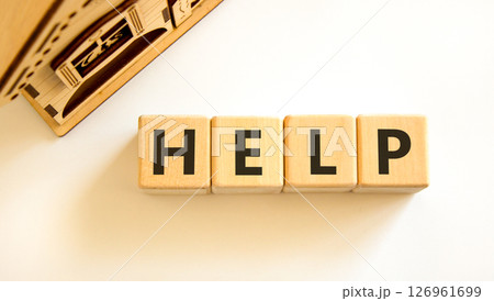 Help symbol. Concept word Help on beautiful wooden blocks. Beautiful wooden house. Beautiful white table white background. Business, lifestyle, support and help concept. Copy space. 126961699
