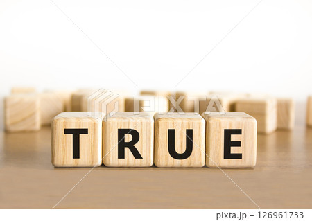 True symbol. Concept word True on beautiful wooden blocks. Beautiful wooden table white background. Business, lifestyle, support and true concept. Copy space. 126961733