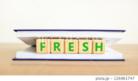 Fresh symbol. Concept word Fresh on beautiful wooden blocks in book. Beautiful wooden table white background. Business lifestyle fresh concept. Copy space. Fresh symbol. Concept word Fresh on beautiful wooden blocks in book. Beautiful wooden table white background. Business lifestyle fresh concept. Copy space. 126961747
