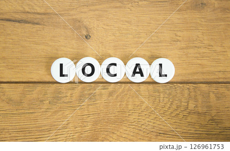 Local symbol. Concept word Local on beautiful white pills circles. Beautiful wooden table wooden background. Business lifestyle local concept. Copy space. Local symbol. Concept word Local on beautiful white pills circles. Beautiful wooden table wooden background. Business lifestyle local concept. Copy space. 126961753