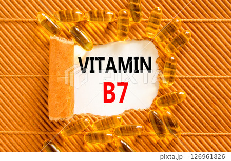 Vitamin B7 biotin symbol. Concept words Vitamin B7 on beautiful white paper. Yellow pills tablets. Beautiful brown background. Medical healthy lifestyle Vitamin B7 concept. Vitamin B7 biotin symbol. Concept words Vitamin B7 on beautiful white paper. Yellow pills tablets. Beautiful brown background. Medical healthy lifestyle Vitamin B7 concept. 126961826